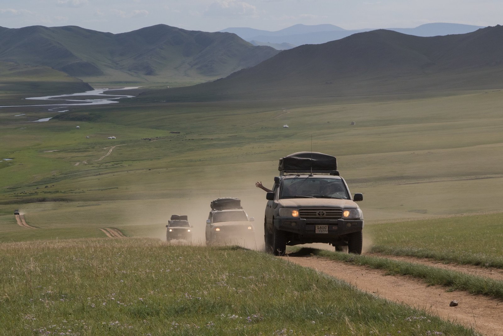 Rider on a Suzuki motorbike crossing the open steppe on a motorbike tour in Mongolia